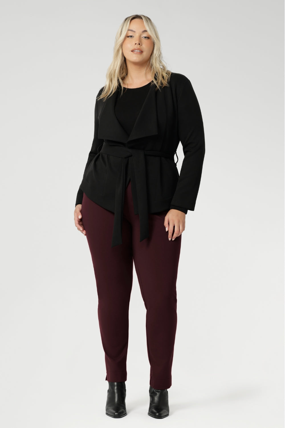 Thoughtfully tailored darts at the back create subtle shaping, while the hemline sits just below the waist and falls slightly longer at the front, adding a refined touch. Sophisticated, versatile, and made to flatter — the Lyndon Jacket blends comfort and elegance. Size 18 model wears her Lyndon Jacket with Burgundy Paxton Pants.