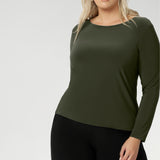 Perfect layering top as the weather cools. The close-to-body fit is enhanced by bust darts for a flattering silhouette, while long sleeves offer warmth. The straight hemline at the front and longer curved hemline at the back add a modern touch to this versatile piece. Available in sizes 8 to 24. Plus size woman wears her top with wide leg black pants.