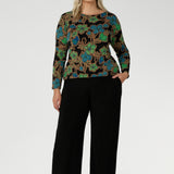 Plus size woman wears her printed top with classic womans workwear pants. Available in sizes 8-24, this top is Australian Made, ensuring quality and craftsmanship. It’s a versatile piece that will effortlessly elevate your everyday wardrobe.