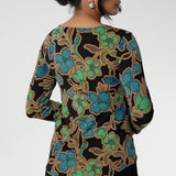 The Mason Top is an essential addition to your wardrobe, perfect as a base layer when the weather cools. Featuring chic, clean lines and an elegant boat neckline, this top offers effortless style in the Secret Garden print. The design features a black base adorned with a floral pattern in soft shades of opal blue, green, and burnt gold.