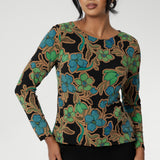 Size 10 woman wears a boat neck jersey top with long sleeves. In a floral print, this slim-fit jersey top sits well under jackets for workwear.