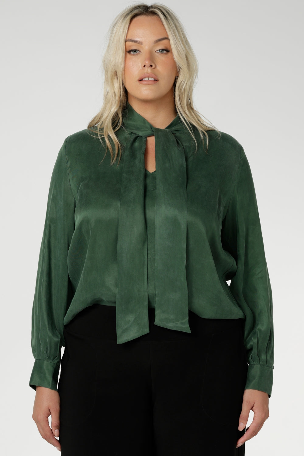 Crafted from suede touch Tencel that has a luxurious feel and drape. Proudly made in Australia in sizes 8-24. The Matisse Shirt in Deep Green is a pull-on style with a tie neckline, crafted from soft, fluid fabric. Blouson sleeves and buttoned cuffs add a polished finish. Matisse is a semi-fitted pull on style V-neckline shirt with extended neck ties, back pleats and bishop sleeves.