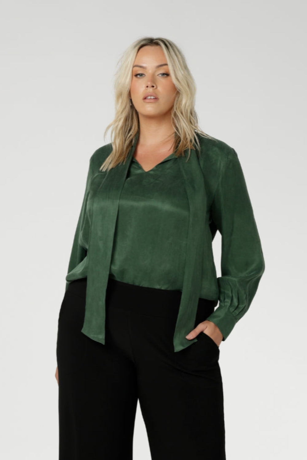 Crafted from suede touch Tencel that has a luxurious feel and drape. Proudly made in Australia in sizes 8-24. The Matisse Shirt in Deep Green is a pull-on style with a tie neckline, crafted from soft, fluid fabric. Blouson sleeves and buttoned cuffs add a polished finish. Matisse is a semi-fitted pull on style V-neckline shirt with extended neck ties, back pleats and bishop sleeves.