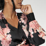 The Matisse Shirt brings timeless romance to your wardrobe. Size 10 woman wears floral blouse tucked into her straight leg pants.