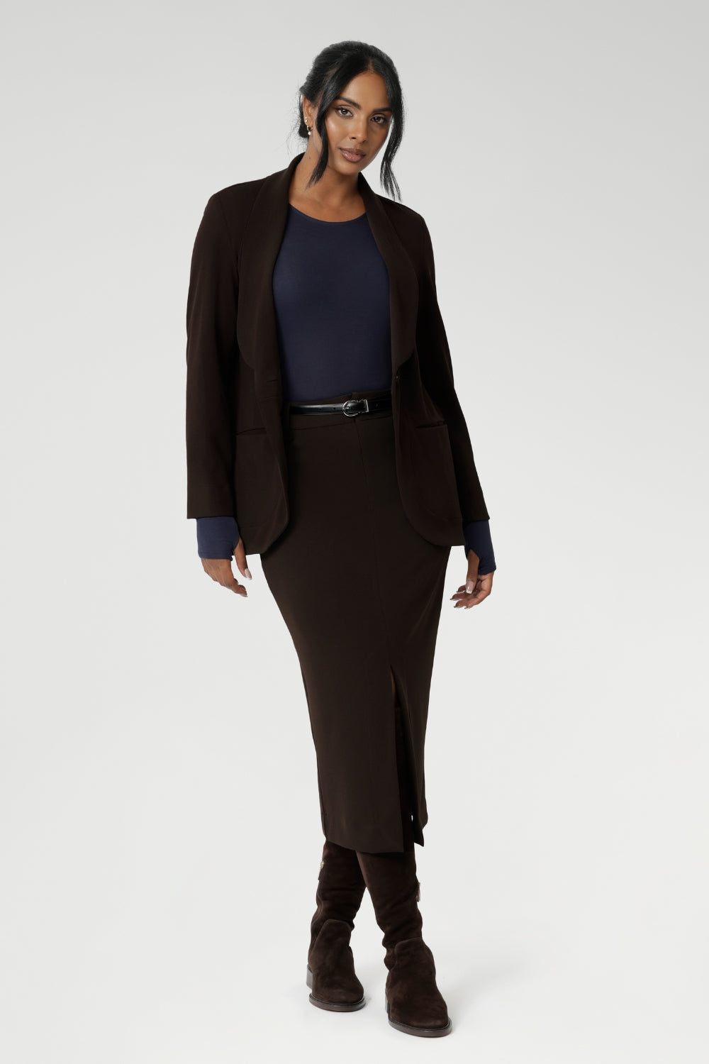 Light weight woman's workwear blazer that offers elevated style. Size 10 woman wears workwear blazer in cocoa colour, crafted from quality scuba crepe fabric. Worn with Bryn Top in Navy. Long blazer offers full body stretch and comfort. Australia made by Leina & Fleur in sizes 8-24.