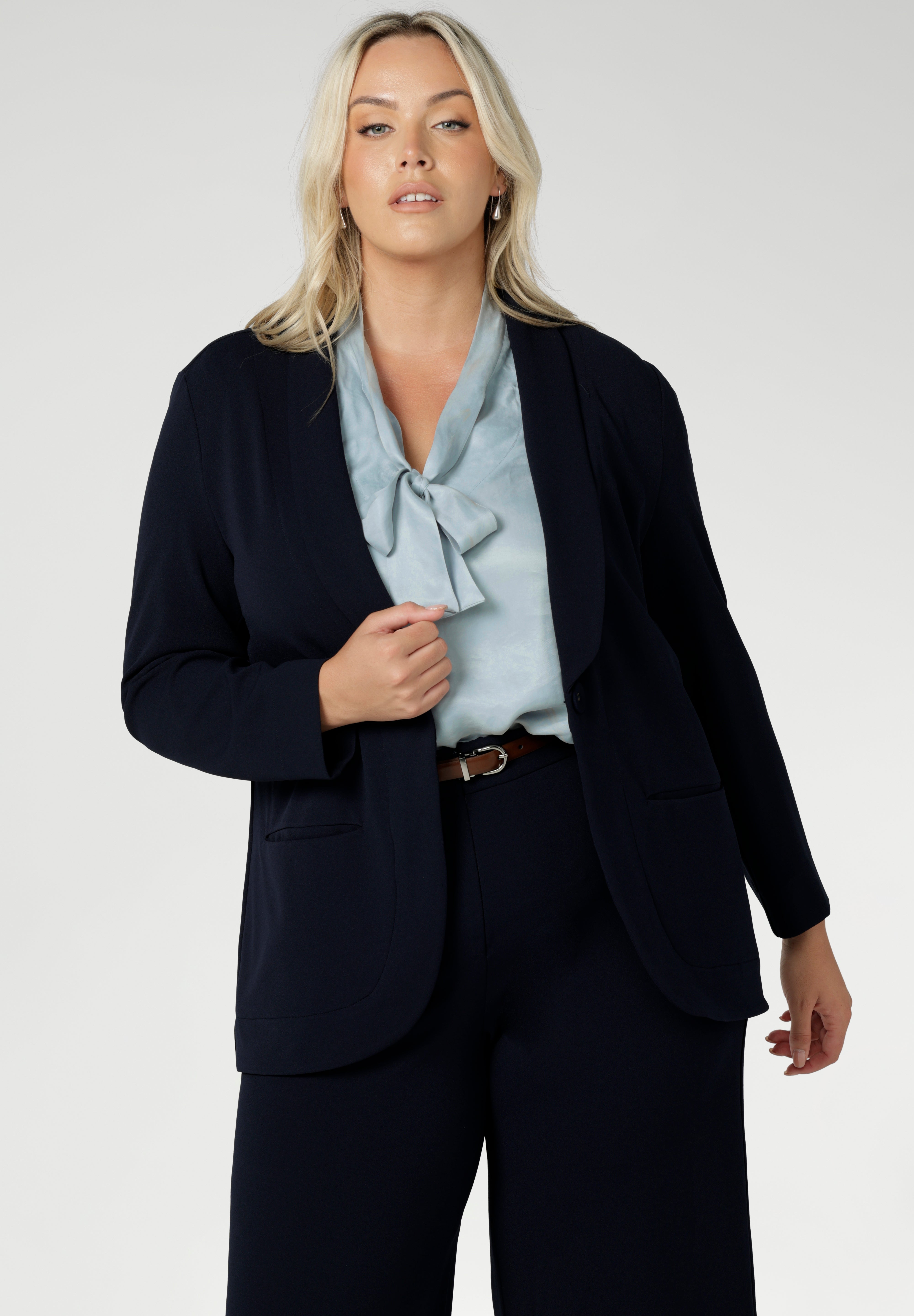 The Michael Shirt in Ice Blue is the perfect blend of modern elegance and workwear chic designed to effortlessly transition from workwear to evening style. This powder blue blouse has flutter sleeves and neck ties that can be tied up with a bow or left undone for a relaxed tuxedo look. Available in size 8-24.