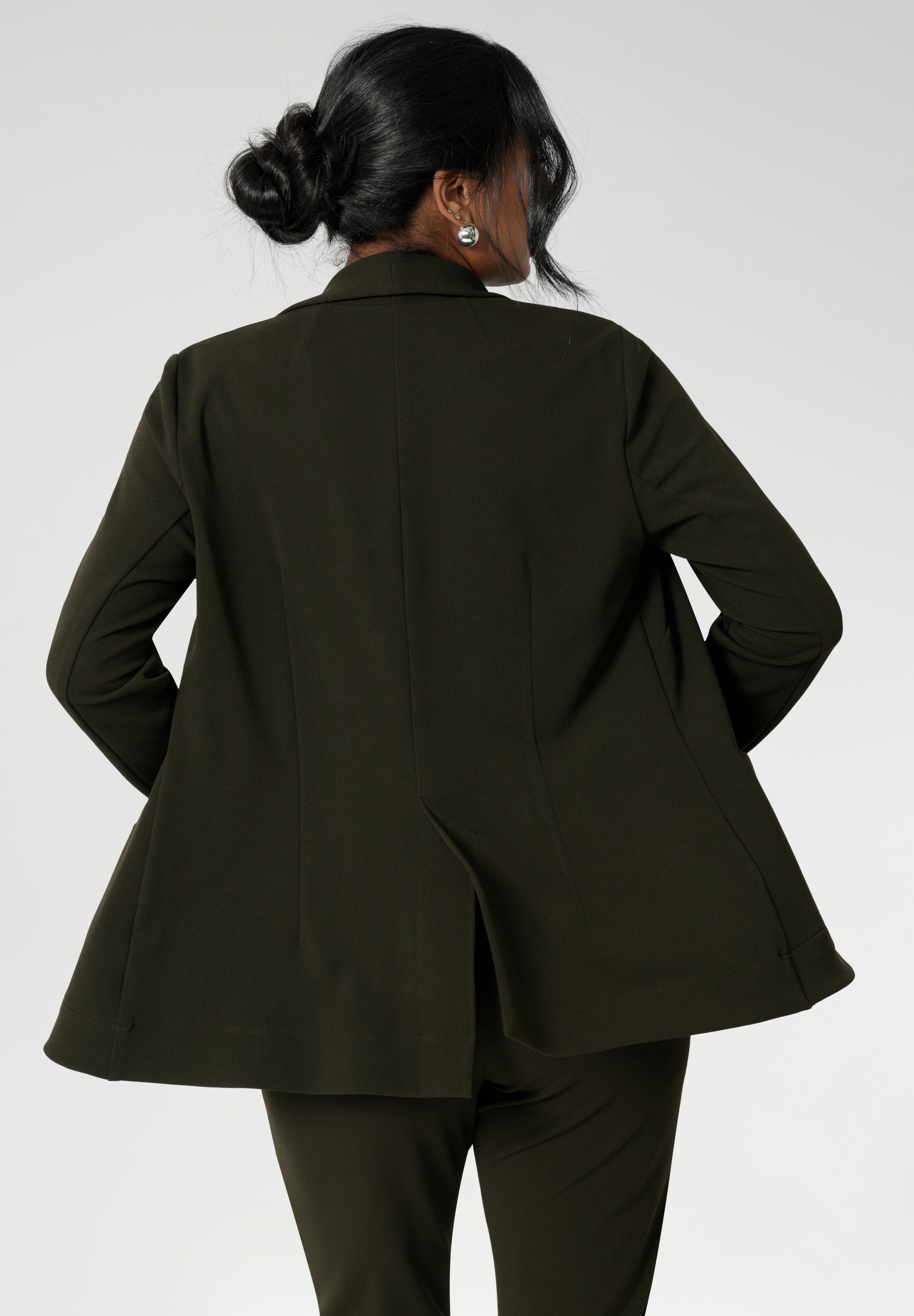 Back view image of Olive Merit blazer made from Scuba crepe, easy care fabric. With functional patch pockets and tailored shawl collar, you will look stylish in all corporate and casual occasions. Woman's workwear clothing made in Australia sizes 8-24.