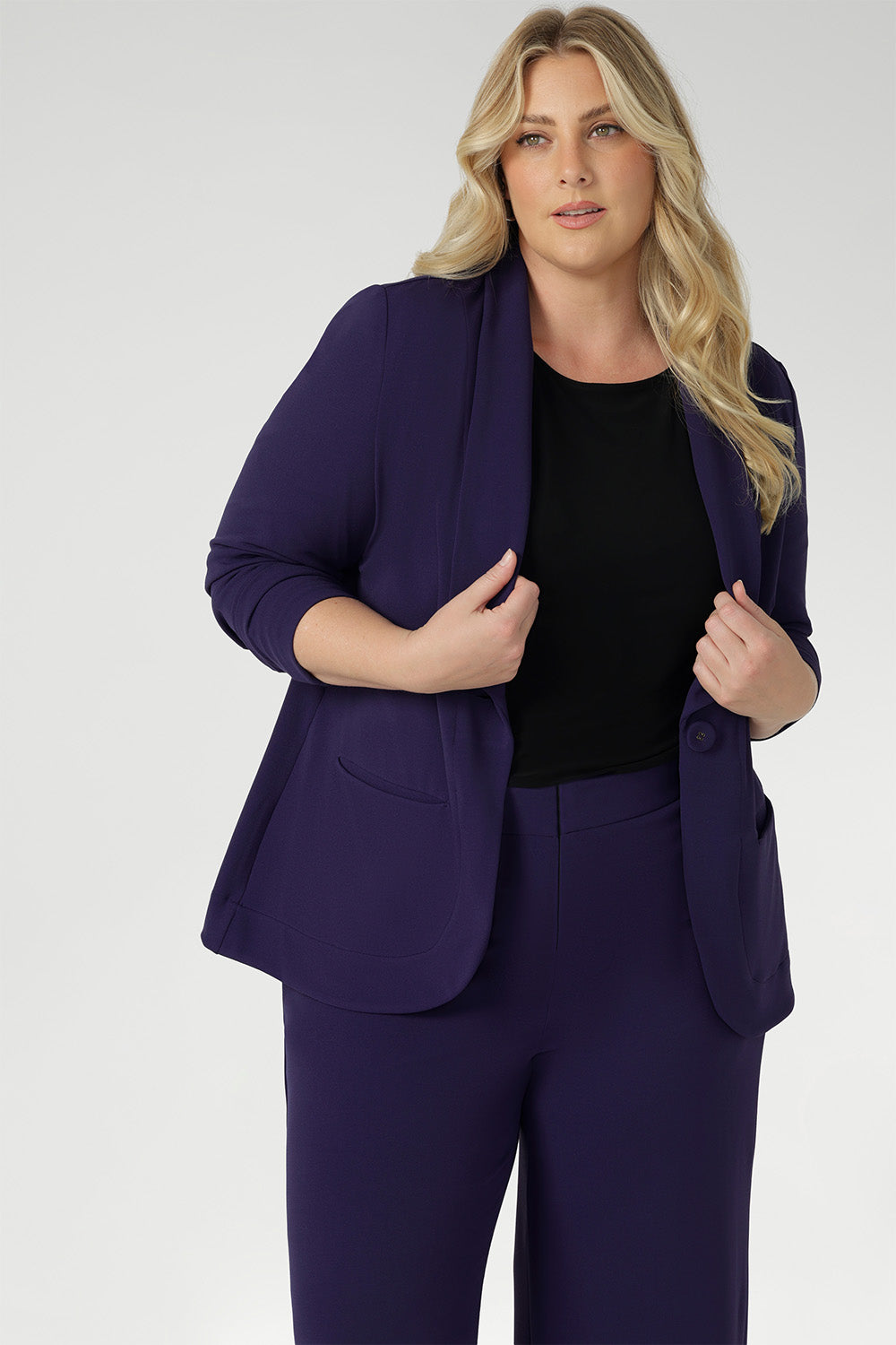 The body-contouring silhouette is enhanced by bust and back darts, while functional slit pockets and a centre-back vent ensure both polish and practicality. Deep hems with refined topstitch detailing and a breathable buggy lining through the back complete this elevated look.