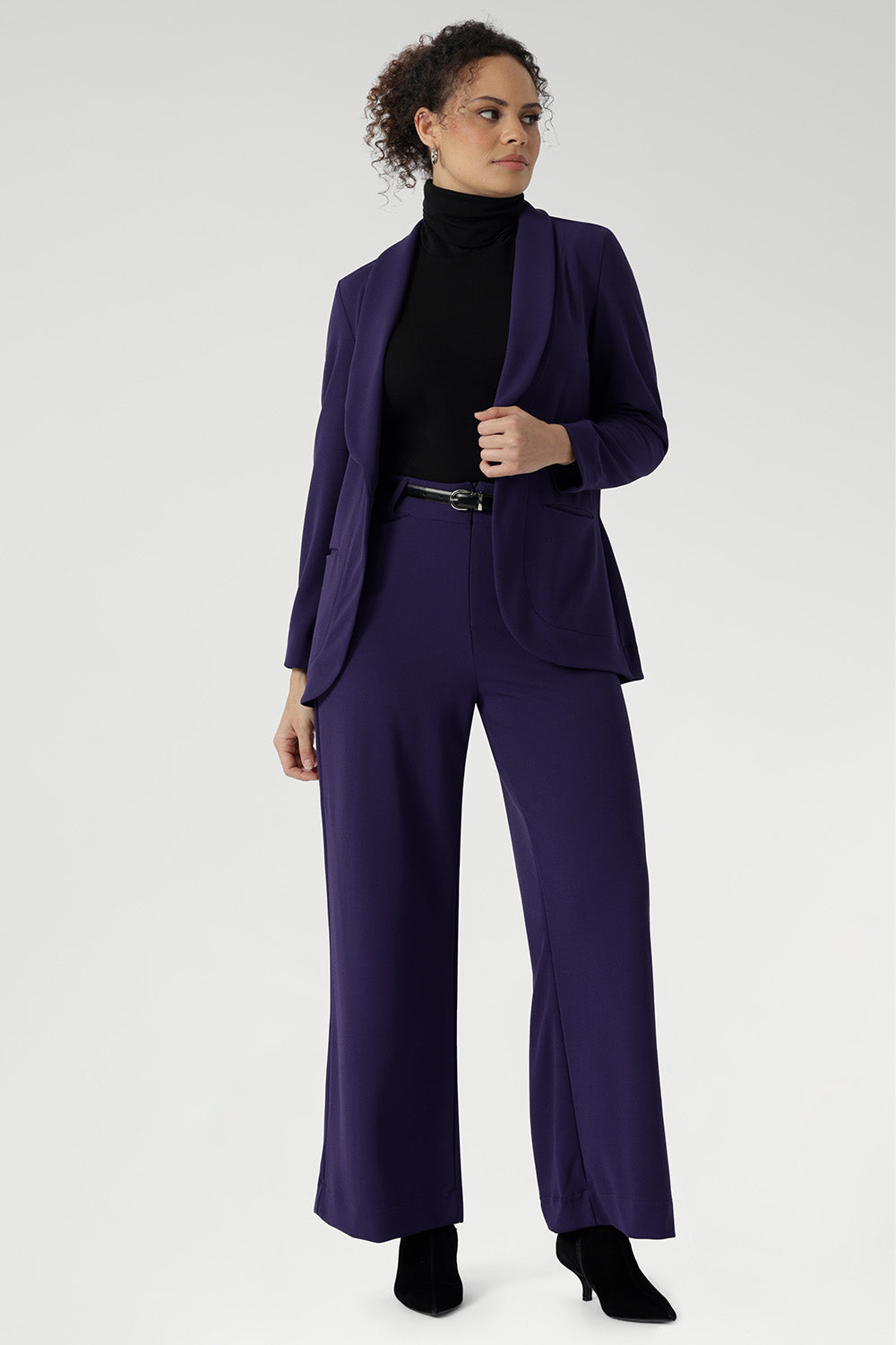 This expertly tailored jacket delivers timeless sophistication with a contemporary edge, featuring a sharp tuxedo-style shawl collar, a button-up front, and full-length sleeves with foldable cuffs for versatile styling.