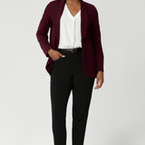 The design features a longline, relaxed fit that creates a sophisticated yet comfortable silhouette. The extended shawl collar adds an elegant touch to the piece, while the button-up front provides a classic, polished finish. Australian made from easy care fabric.