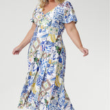 The empire line silhouette and twist-front V-neckline create a flattering fit, complemented by flutter sleeves and a double-layered bodice for gentle coverage. Finished with a flowing overlap-style skirt, this maxi dress moves beautifully from daytime events to evening celebrations with effortless sophistication.