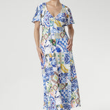 The Sicilian-inspired mosaic print blends shades of cobalt, yellow, brown, and green for a vibrant yet refined aesthetic. With flutter sleeves, a double-layered bodice for comfort and coverage, and a flowing overlap-style maxi skirt, this Australian-made jersey dress is perfect for garden parties, special events, or weddings.