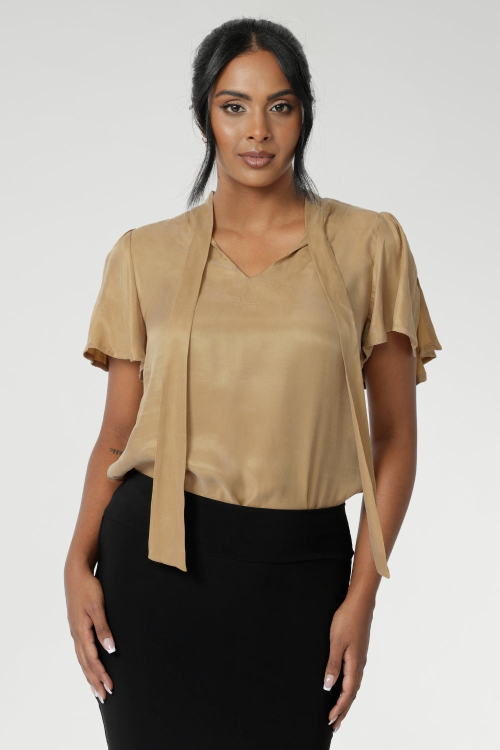 The Michael Shirt in Gold is the epitome of chic, elevated style, designed to seamlessly transition from professional workwear to elegant evening wear. Evening blouse has gold coloured fabric, that provides beautiful drape and a soft touch on the skin. Available in 2 colours in size 8-24.