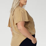 Image shows plus size woman wearing evening blouse, featuring a shirttail hemline. This women's blouse is versatile enough to be tucked into skirts or trousers for a polished look. Available in sizes 8-24 and exclusively online at Leina & Fleur, this shirt is the perfect addition to any wardrobe.
