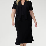 . Whether styled for the office, packed for a weekend escape, or dressed up for an evening out, the Michael Top delivers effortless sophistication with every wear. Plus size model wears her Micheal Shirt in Black