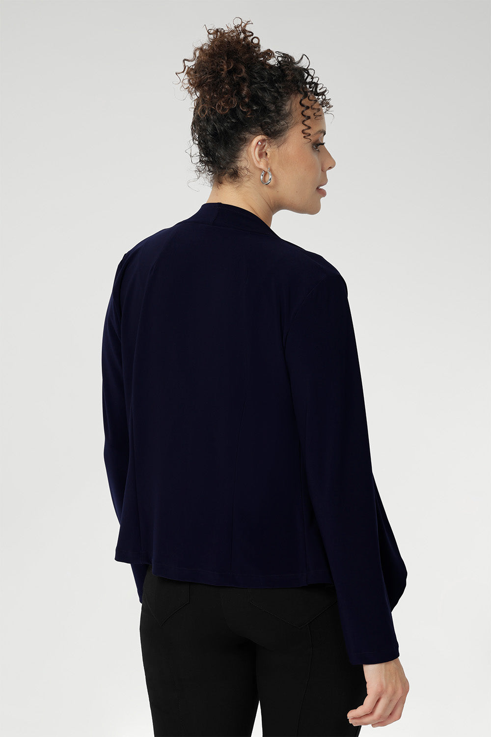 Back darts create a flattering shape, while the angled front hemline and full-length sleeves add a modern, sophisticated edge. Designed for both versatility and style, this timeless piece is proudly made in Australia and perfect for year-round wear.