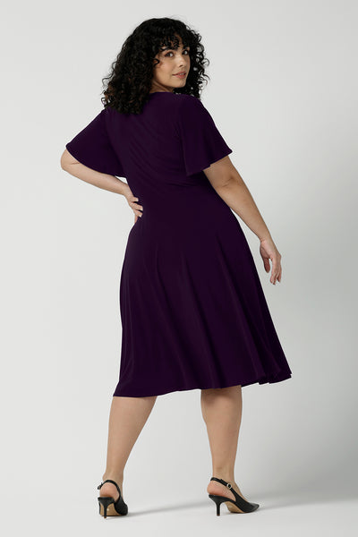 Back view of a Monique dress in Amethyst. Jersey dress with flutter sleeve and rounded neckline. Full circle skirt and pockets. Made in Australia for women size 8 - 24.
