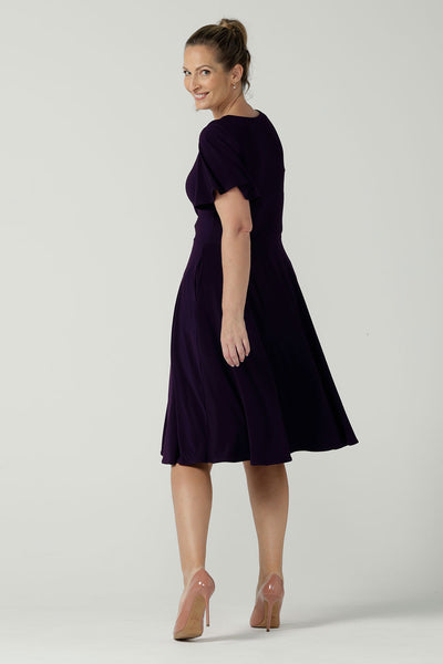 Back view of the Monique dress in Amethyst. Jersey dress with flutter sleeve and rounded neckline. Full circle skirt and pockets. Made in Australia for women size 8 - 24.