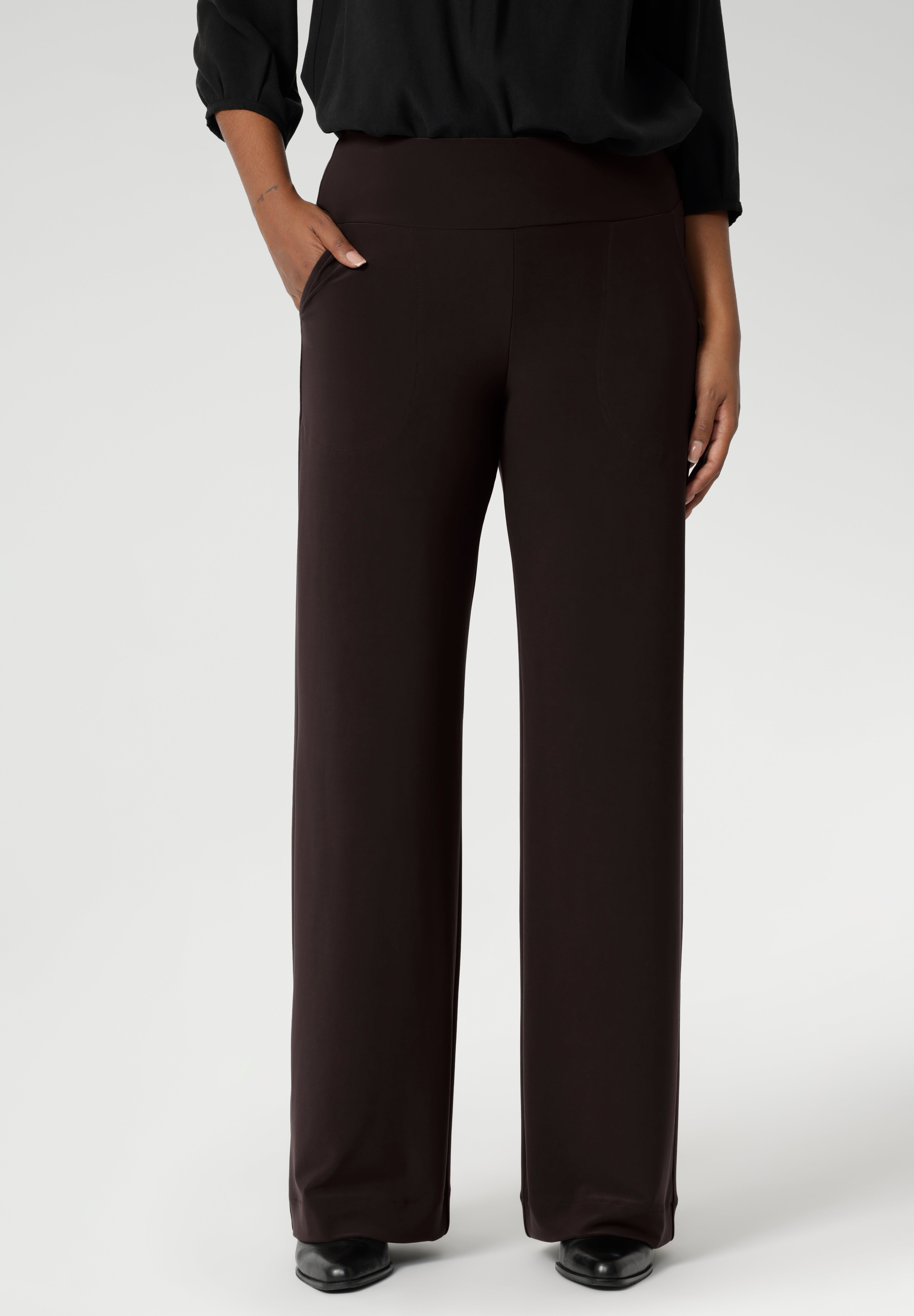 The pant includes a deep, double-layer waistband, side pockets with topstitching detail, a straight-leg cut, and a deep hem for added structure. Available in 3 lengths and in sizes 8-24.
