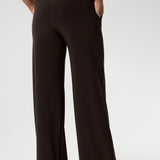 The pant includes a deep, double-layer waistband, side pockets with topstitching detail, a straight-leg cut, and a deep hem for added structure. Available in 3 lengths and in sizes 8-24.