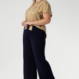 Women's size inclusive work pants. Pictured on a size 18 woman, these comfortable navy corporate pants. Full length navy, straight leg pants with stretch. Shop in sizes 8-24. Plus size woman wears the Monroe Pants Navy in the regular length.