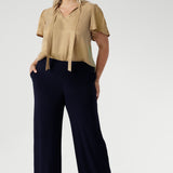 Women's size inclusive work pants. Pictured on a size 18 woman, these comfortable navy corporate pants. Full length navy, straight leg pants with stretch. Shop in sizes 8-24.