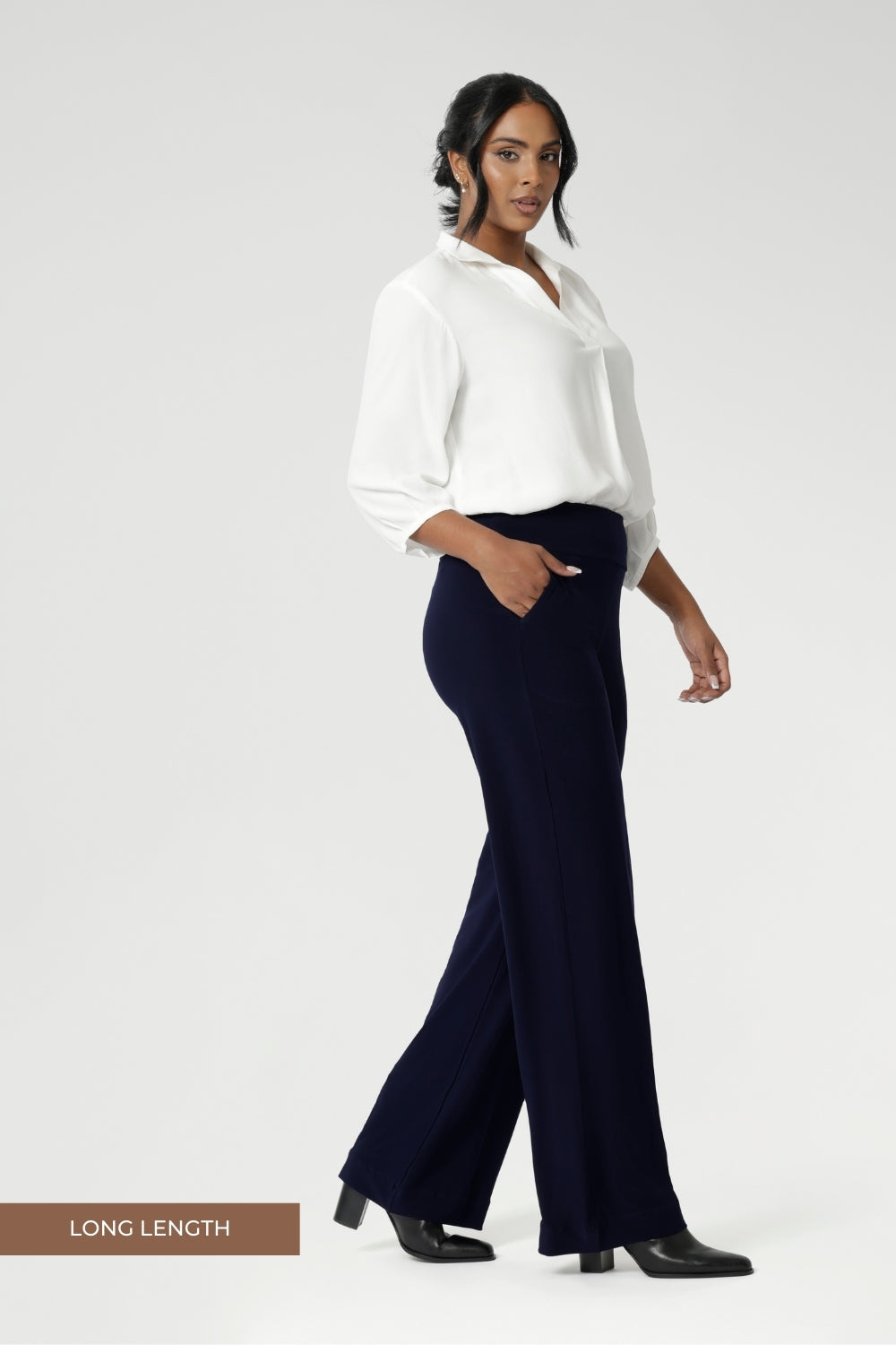 Women's size inclusive work pants. Pictured on a size 10 woman, these comfortable navy corporate pants. Full length navy, straight leg pants with stretch. Shop in sizes 8-24. Over 30s woman wears the Monroe Pants Navy in the long length.