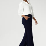 Women's size inclusive work pants. Pictured on a size 10 woman, these comfortable navy corporate pants. Full length navy, straight leg pants with stretch. Shop in sizes 8-24. Over 30s woman wears the Monroe Pants Navy in the long length.