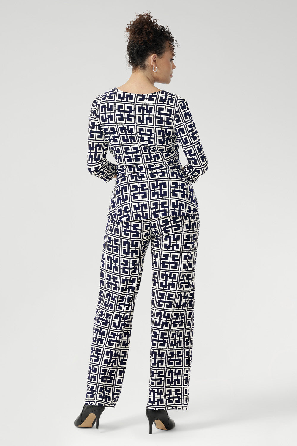 A timeless straight-leg pant designed to move effortlessly from the office to the weekend. Shown here, our size 10 model wears the Kyle Top in Ink Olympia paired with the matching Monroe Pant in Ink Olympia, styled together for a chic, printed jumpsuit effect. Available in sizes 8 to 24, with a choice of three leg lengths for the perfect fit.