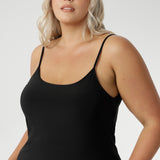 Fully reversible for multiple styling options, it’s the perfect base layer to wear under dresses or separates for smooth, comfortable coverage. Black slip dress for women is seen on size 18 woman with round neck front facing.