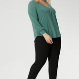 Paeton is ideal for workdays, weekend styling, and effortless winter layering. Available in sizes 8 to 24. Plus size woman wear Paeton Top in Menthol with black tapered leg pants and black kitten heels - Creating a go to work look.