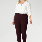 Plus size woman wears Burgundy Paxton Pant. Designed as a pull-on style pant, crafted from dry touch Ponte fabric that provides firm stretch and full body comfort. Size 18 model wears the Garcia Jacket in the matching burgundy colour for a coordinated suiting look.