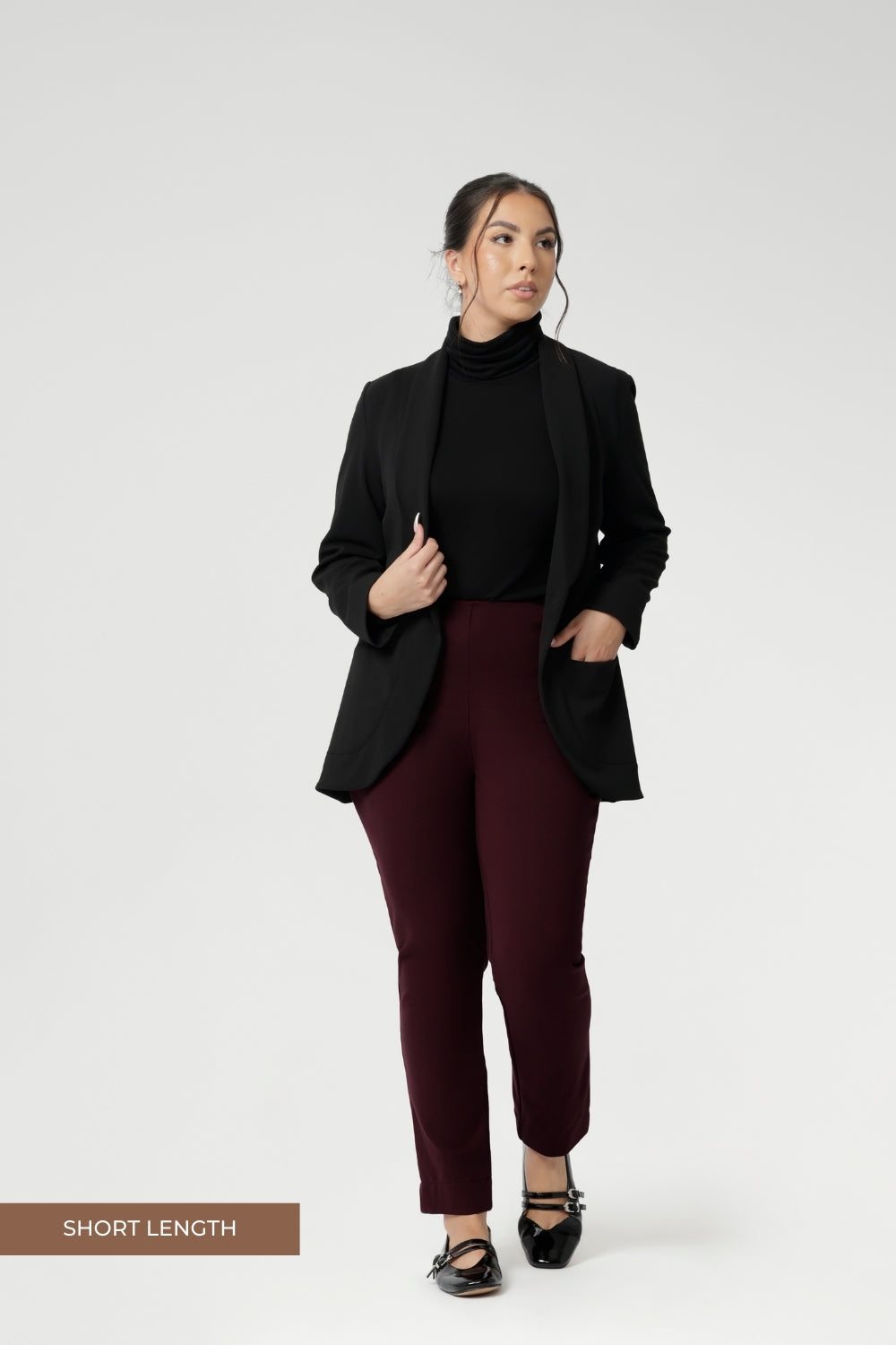 Petite Height woman wears Size 10 pull-on style pant, crafted from stretchy, dry touch Ponte fabric that provides firm stretch and full body comfort. Available in sizes 8-24. Workwear pants are available in 3 lengths.