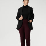 Petite Height woman wears Size 10 pull-on style pant, crafted from stretchy, dry touch Ponte fabric that provides firm stretch and full body comfort. Available in sizes 8-24. Workwear pants are available in 3 lengths.