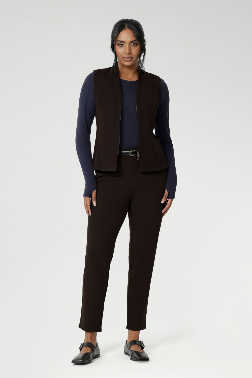 Made from a luxurious Scuba Crepe Jersey fabric, it provides a soft, textured feel with comfortable stretch. The fitted vest features a flattering V-neckline, sleeveless design, and a two-way opening zip for added flexibility. It also includes back side panels for a tailored fit and is available in sizes 8-24. Proudly made in Australia, this vest is a must-have for those seeking both style and comfort.