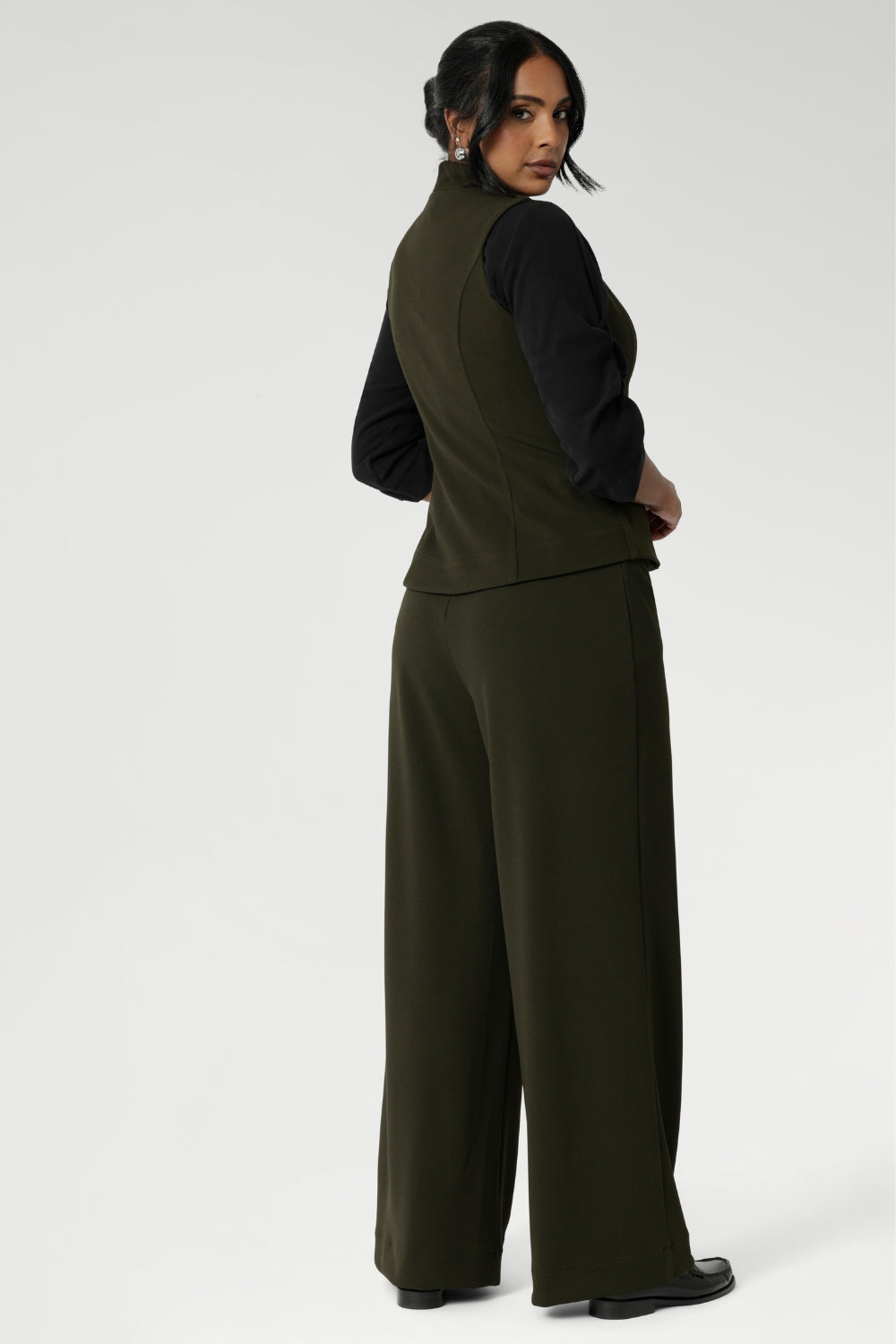 Elevate your style with this chic and functional addition to your closet. Made from a luxurious Scuba Crepe Jersey fabric, it provides a soft, textured feel with comfortable stretch.