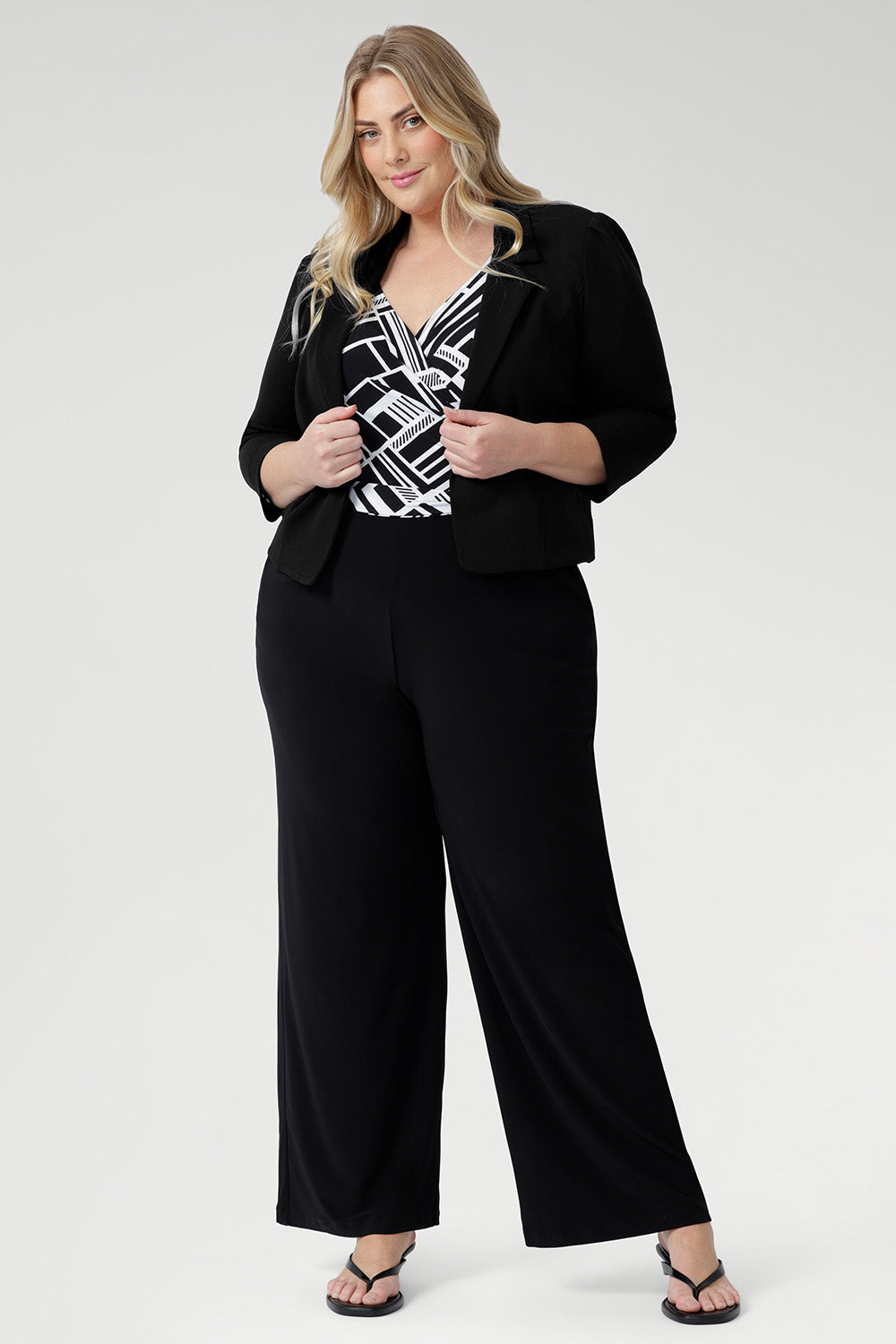 The Puzzle Jumpsuit in Moderno is a statement-making one-piece crafted from our signature dry-touch jersey with soft stretch, designed to offer effortless style and all-day comfort. Showcasing a striking black and white geometric print across the wrap-style bodice, this jumpsuit features a flattering self-tie waist and a double-layered back for a refined and supportive fit.