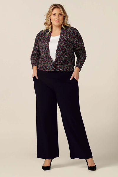 A cardigan-come-jacket, a printed jersey Jacardi is worn with straight-leg black jersey pants and a white bamboo jersey top to show how to buy work wear jackets in colour and print to update your workwear style.