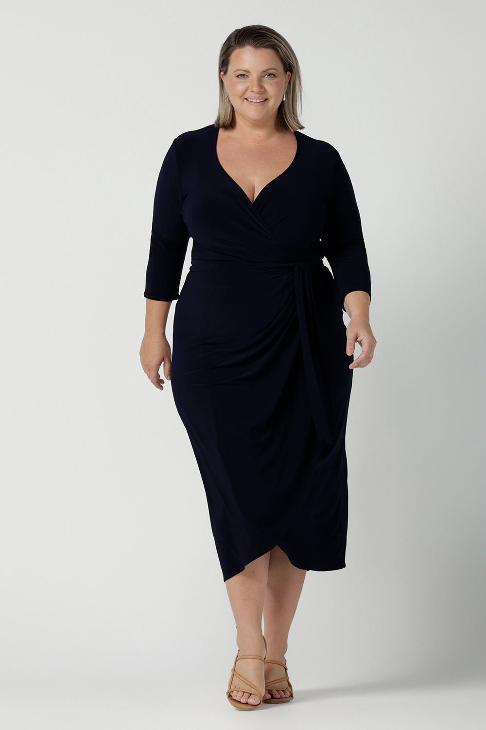 Size 18 curvy woman wears the Robin dress in Navy. Midi length with 3/4 sleeves. V-neckline with a functioning wrap. A great work to weekend piece. Made in Australia for women size 8 - 24.