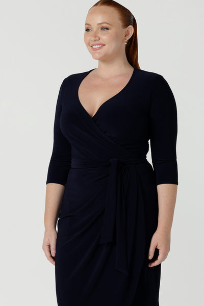 Size 12 woman wears the Robin dress in Navy. Midi length with 3/4 sleeves. V-neckline with a functioning wrap. A great work to weekend piece. Made in Australia for women size 8 - 24.