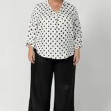 Proudly made in Australia, this pant is available in sizes 8-24, offering an inclusive fit for all women. Black work wear pants are styled with black spotted white blouse and brown small heel. Offering a smart casual office chic look.