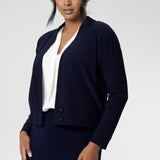 The Jacardi features long sleeves, this jacket-cardigan hybrid is the perfect trans-seasonal cover up for women. Move into the cooler months in style, with this comfortable jacket for workwear and casual layering. Available in sizes 8-24. Size 10 woman wears navy cardigan paired with navy work skirt and white blouse.
