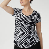 The Sawyer Top in Moderno is crafted from our signature dry-touch stretch jersey, offering the perfect balance of structure and softness for everyday wear. Designed with a flattering fitted silhouette, this versatile top features a classic round neckline, short sleeves, and a curved shirttail hemline that adds a modern touch to any outfit.