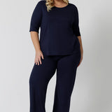 Showing good lounge pants for curvy women, a size 18 wears straight, wide leg navy blue, plus size lounge pants in bamboo jersey with a navy blue, slouchy tee top. Breathable and thermo-regulating this is a good pyjama set for night sweats and hot flushes. Stay cool for summer nights with breathable sleepwear by L&F Australia in sizes 8-24.
