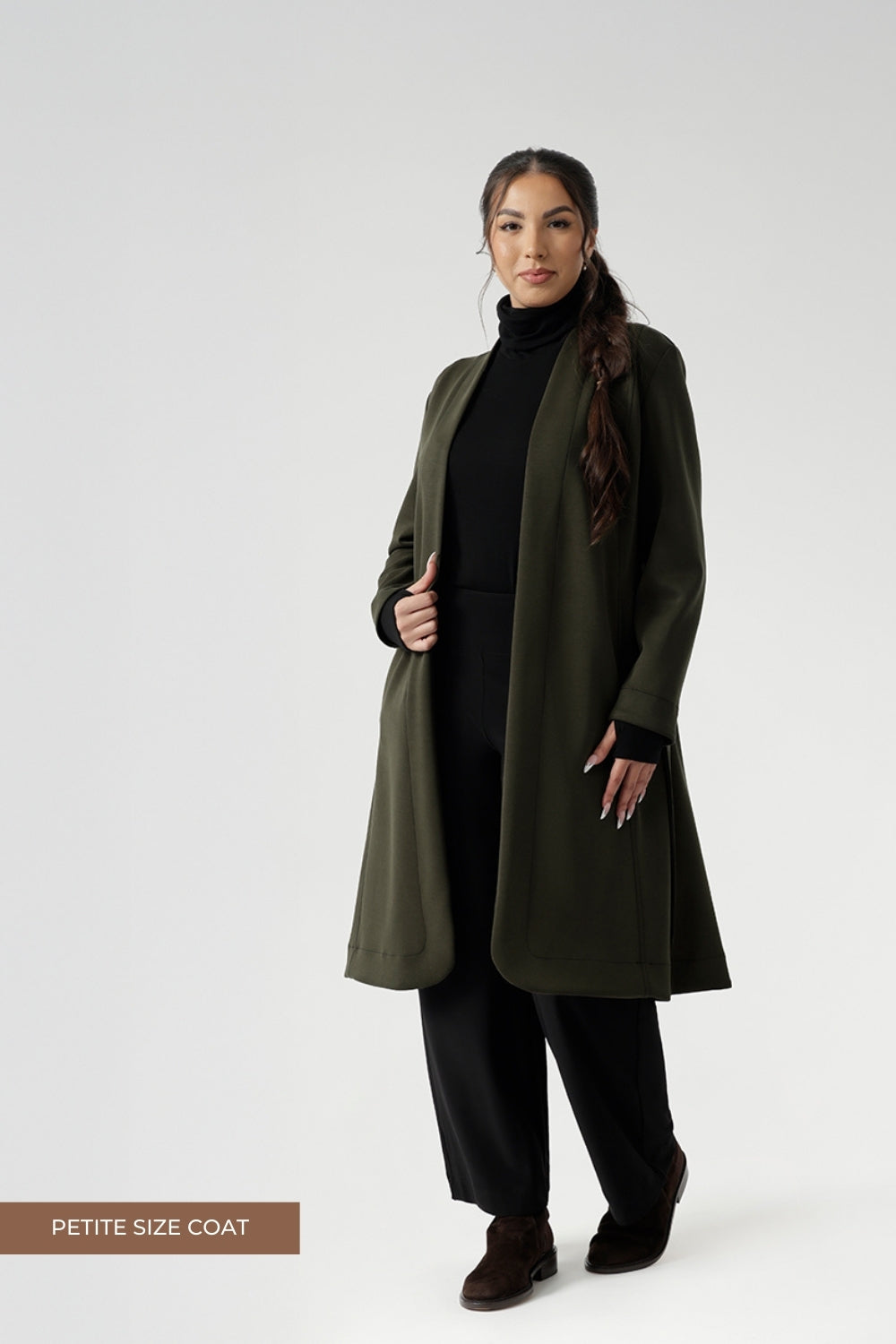 Petite height model wears the Sorel Trench Coat over Monroe Pants & Bryn Top in black for a warmer layer over work wear outfit. The buggy lining at the back ensures added comfort, while the waist seam at the back provides a flattering shape. With belt loops and a fabric waist tie, this versatile trench coat is available in sizes 8-24 and is proudly made in Australia.