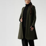 Petite height model wears the Sorel Trench Coat over Monroe Pants & Bryn Top in black for a warmer layer over work wear outfit. The buggy lining at the back ensures added comfort, while the waist seam at the back provides a flattering shape. With belt loops and a fabric waist tie, this versatile trench coat is available in sizes 8-24 and is proudly made in Australia.