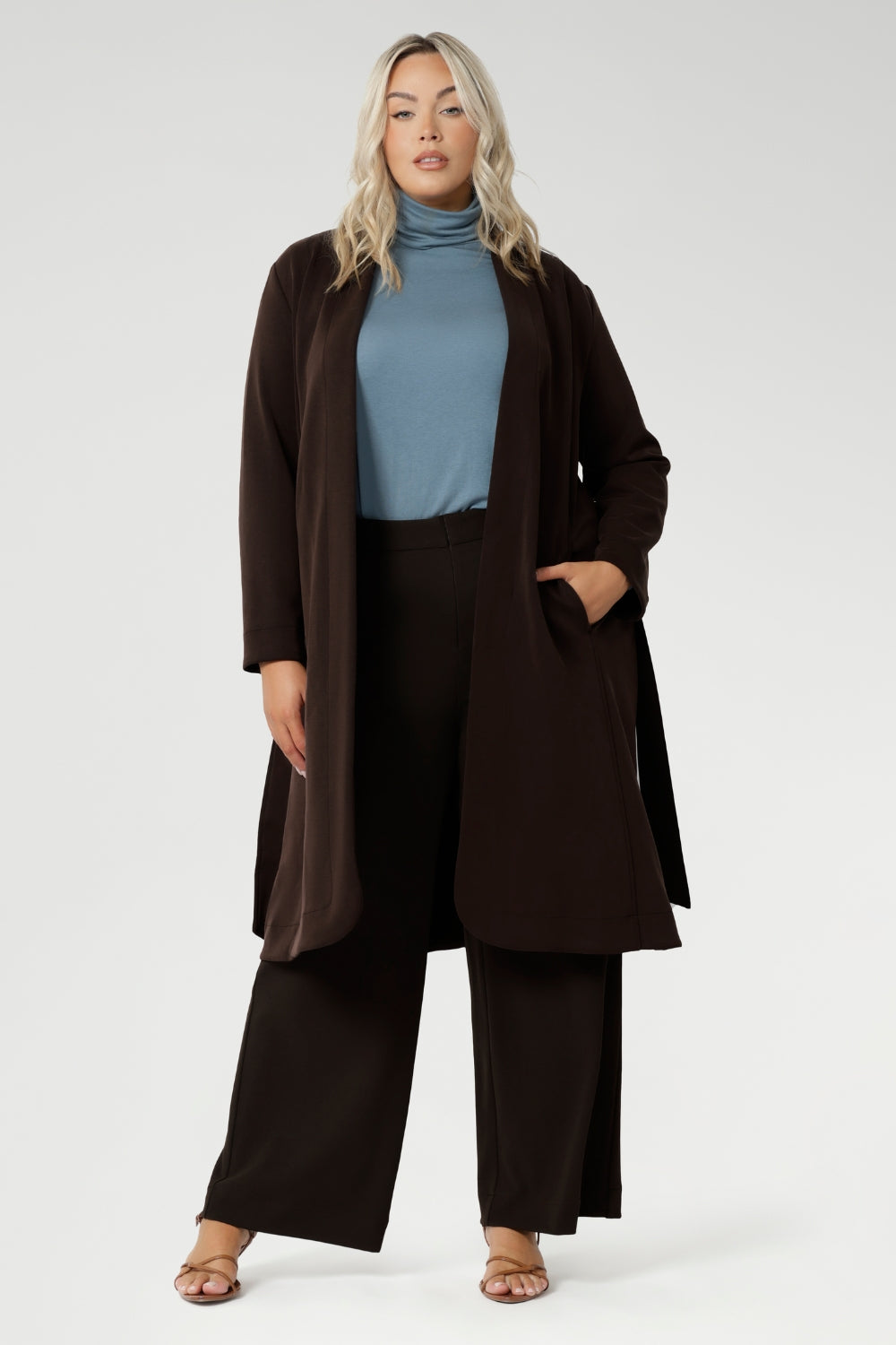 Made from a blend of stretchy Tencel wool fabric, it offers both flexibility and coziness, making it the perfect layering piece for cooler weather. Size 18 model wears her turtle neck top under her soft suiting, pairing her Pennyworth vest over the tencel wool top.