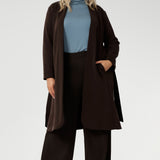 Made from a blend of stretchy Tencel wool fabric, it offers both flexibility and coziness, making it the perfect layering piece for cooler weather. Size 18 model wears her turtle neck top under her soft suiting, pairing her Pennyworth vest over the tencel wool top.