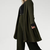 Crafted from a luxurious winter-weight Modal fabric, it combines soft structure and stretch, making it the perfect travel companion for those seeking both style and comfort. The coat features tailored panels at the front with concealed pockets seamlessly integrated into the seams, along with two-piece long sleeves for a refined fit.