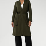 Its grown-on neckline eliminates the need for a collar, offering a sleek, contemporary look. The buggy lining at the back ensures added comfort, while the waist seam at the back provides a flattering shape. With belt loops and a fabric waist tie, this versatile trench coat is available in sizes 8-24 and is proudly made in Australia.
